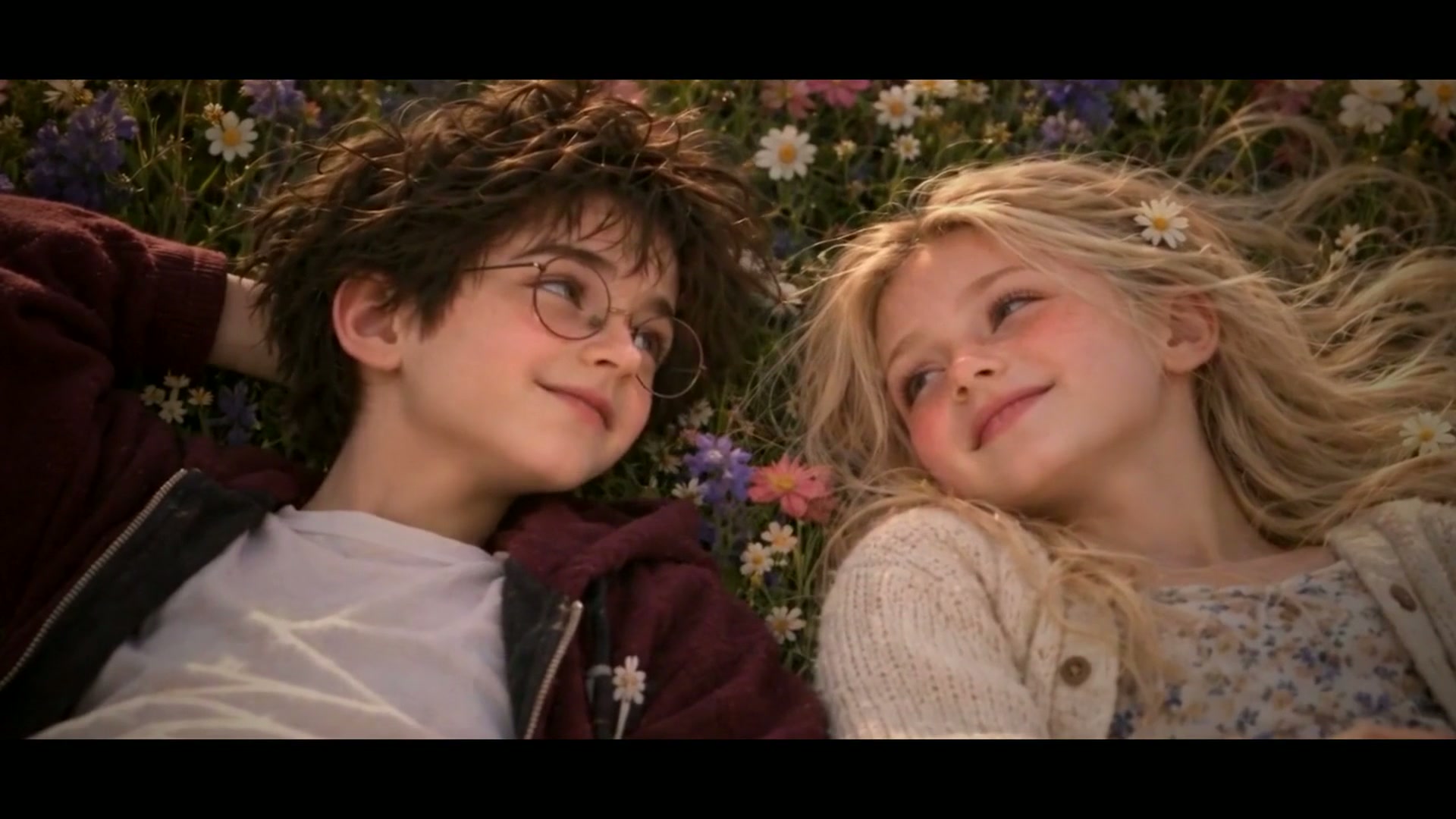 Harry and Draconia as children, lying in a summer meadow
